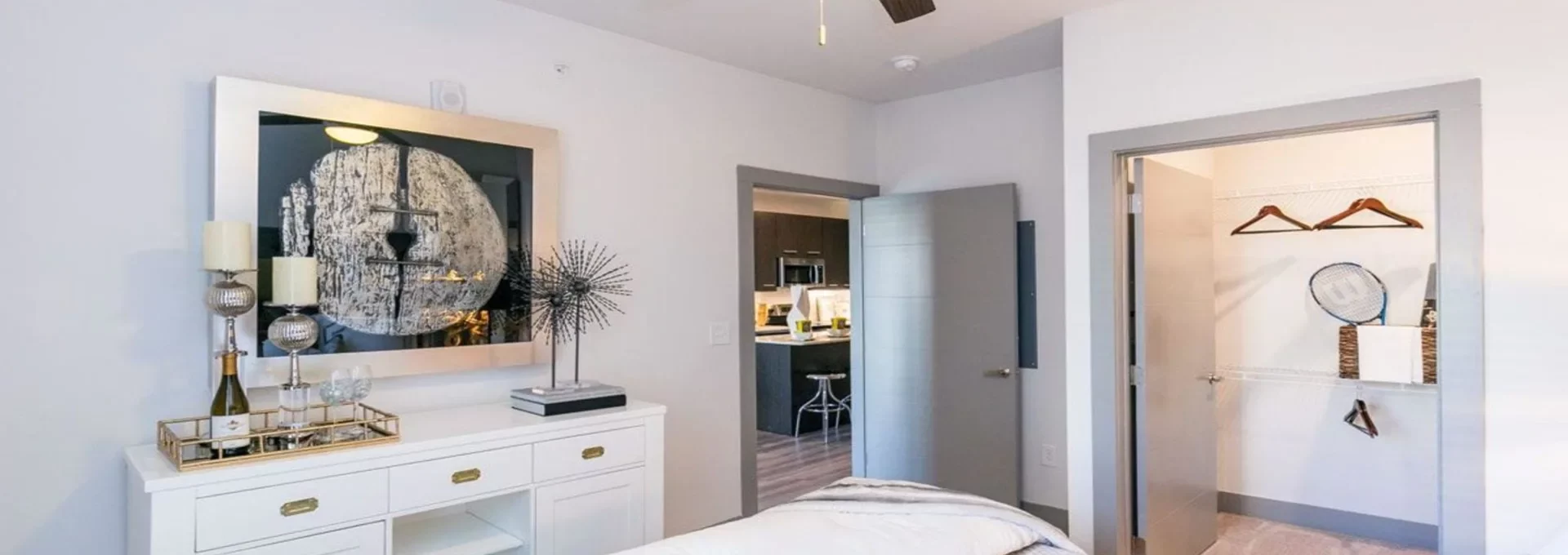 a bedroom with a ceiling fan and white bed at The Argon