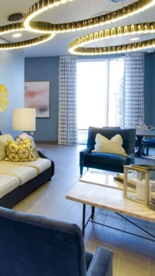 a living room with blue walls and a blue couch at The Argon