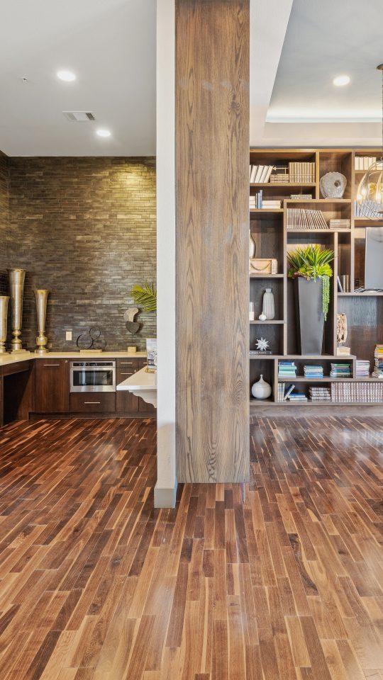 a kitchen with wooden floors and wooden cabinets