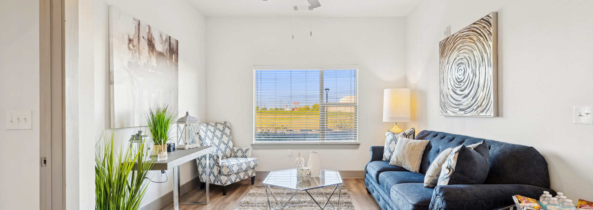 a living room filled with furniture and a window