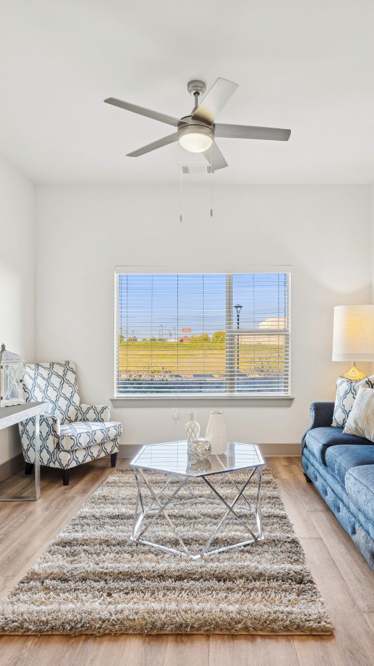 a living room filled with furniture and a window