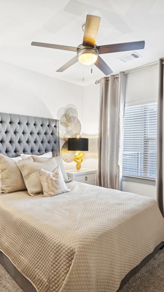 a bedroom with a large bed and a large window