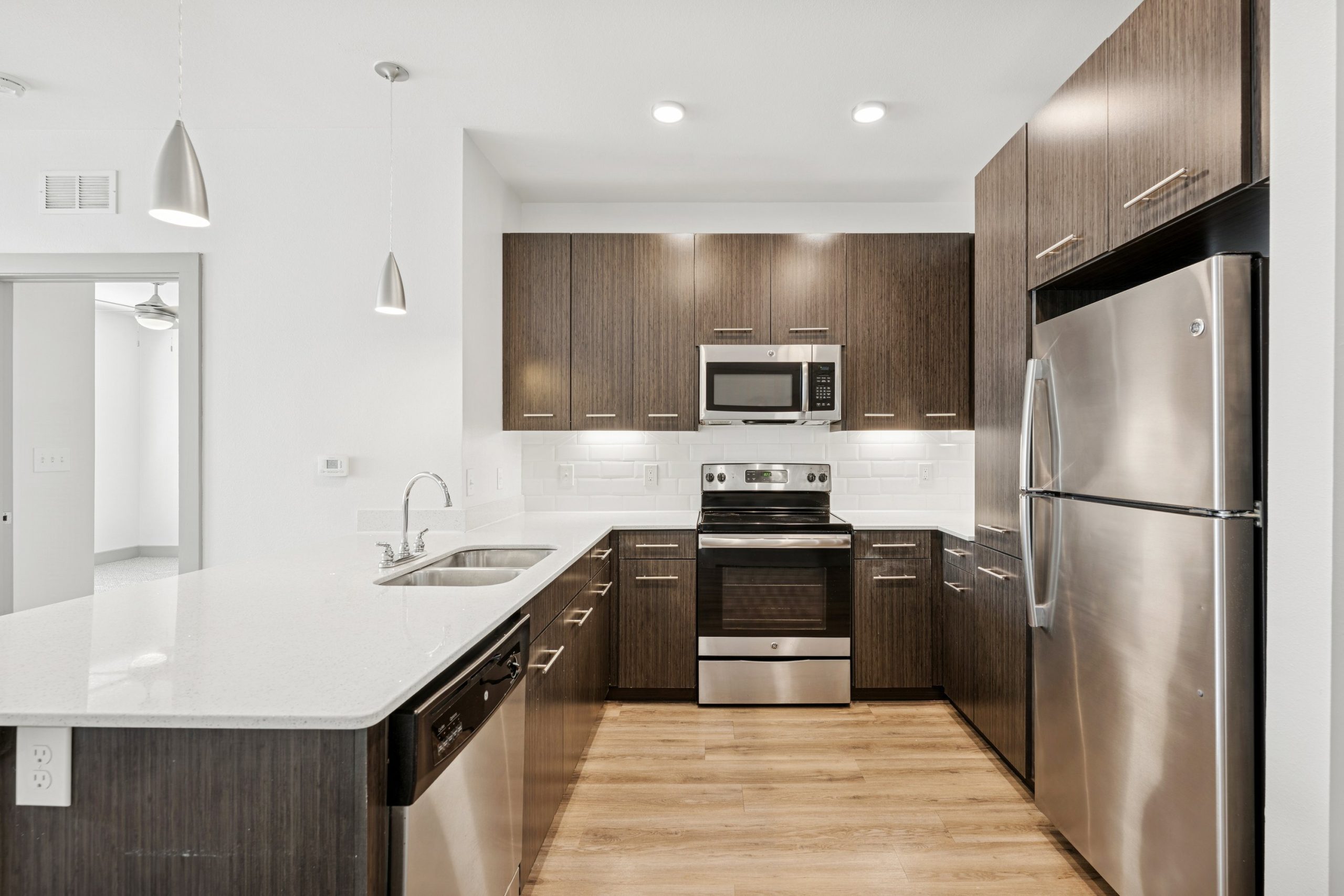 kitchen with recess lighting and brown cabinets